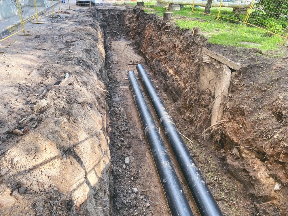 Laying,Of,Underground,Communications,For,Residential,Buildings.,Black,Plumbing,Pipes